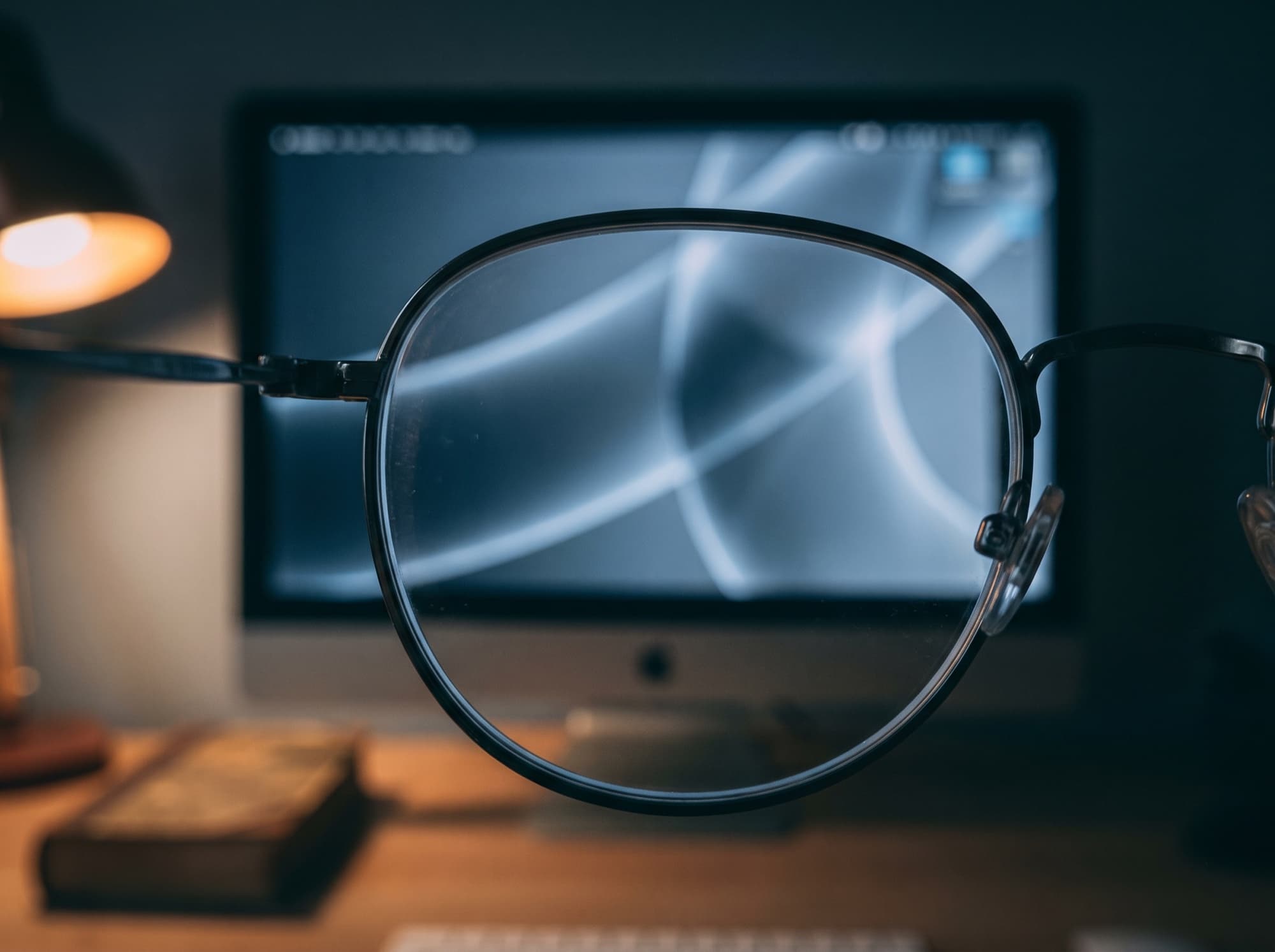 A monitor at night seen sharply edge-to-edge through a clear lens